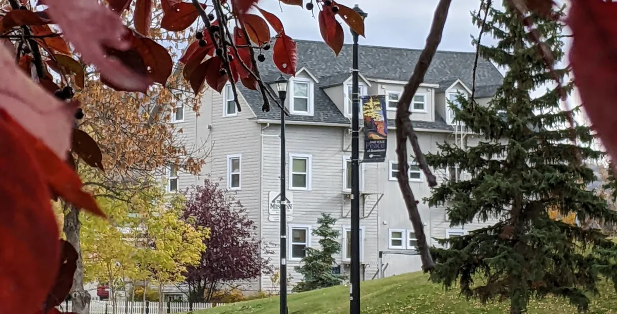 View of Third Mission hotel through trees in fall colors